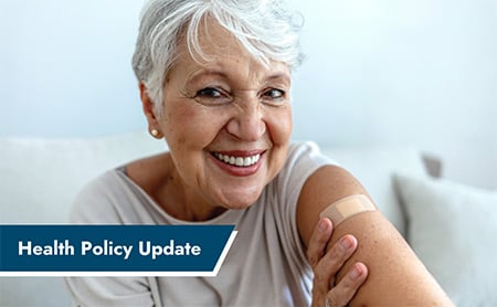 An older woman proudly shows off her bandage after getting a vaccination shot. ASTHO Health Policy Update banner in lower left
