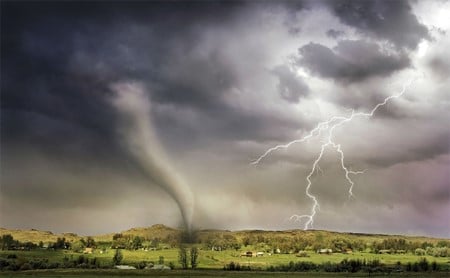 A tornado and lightning strike a rural landscape