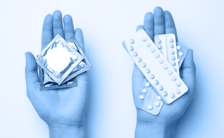 Two hands, one holding condoms, the other holding blister packages of birth control pills, there is a blue wash over the image