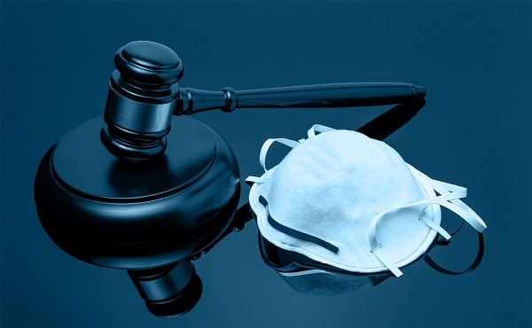 Face mask and gavel on a desk