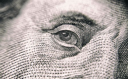 Close-up of the eye on a dollar bill.