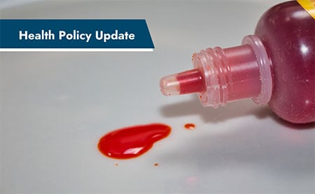 Open bottle with red liquid spilling out, accompanied by a blue banner with the text, "Health Policy Update".
