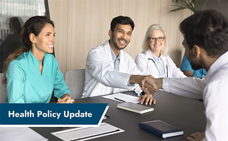 Medical professionals shaking hands over a table with banner in lower left with the text, ‘Health Policy Update’.