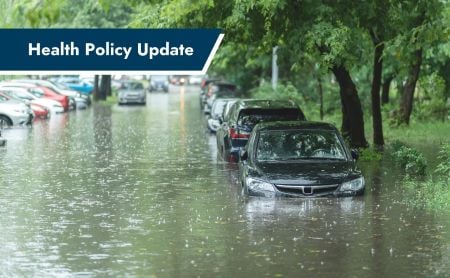 A flooded city street with partially submerged cars and a "Health Policy Update" banner.
