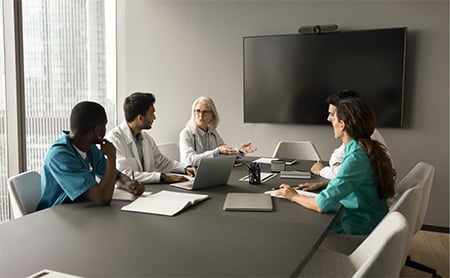 Healthcare professionals meet in a conference room