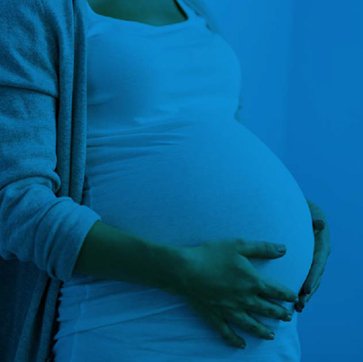 Pregnant woman with hands on her belly in blue tones
