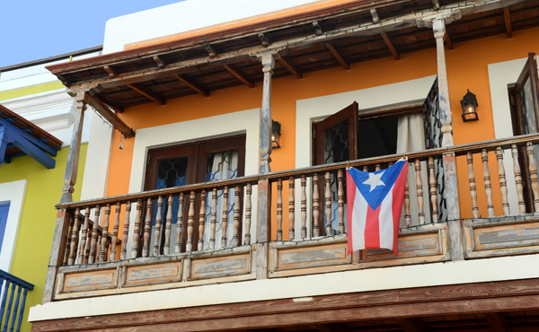 The Puerto Rican flag draped over a balcony
