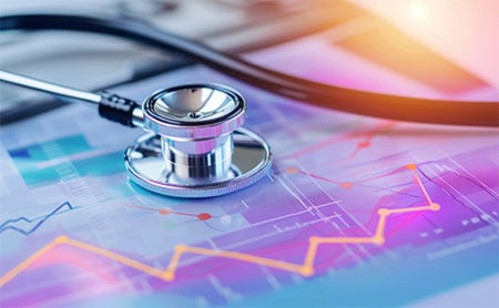 Stethoscope on colorful data charts with line graphs.